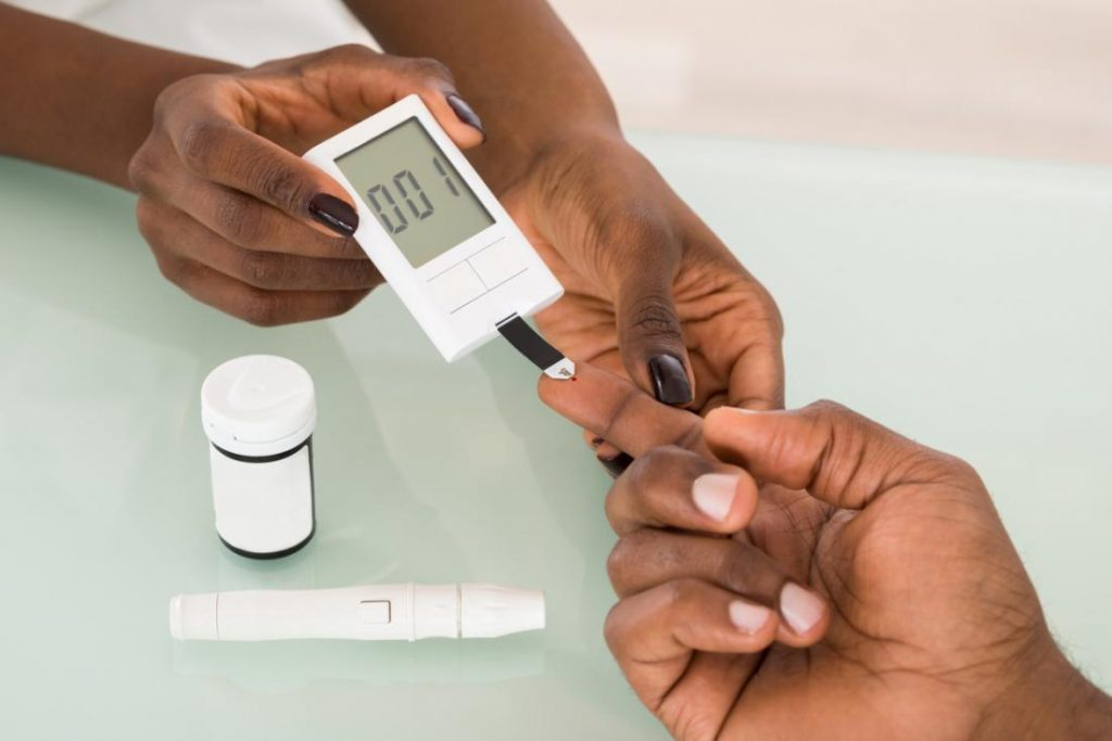 woman-performing-blood-sugar-and-insulin-test-on-man-s-fingertip